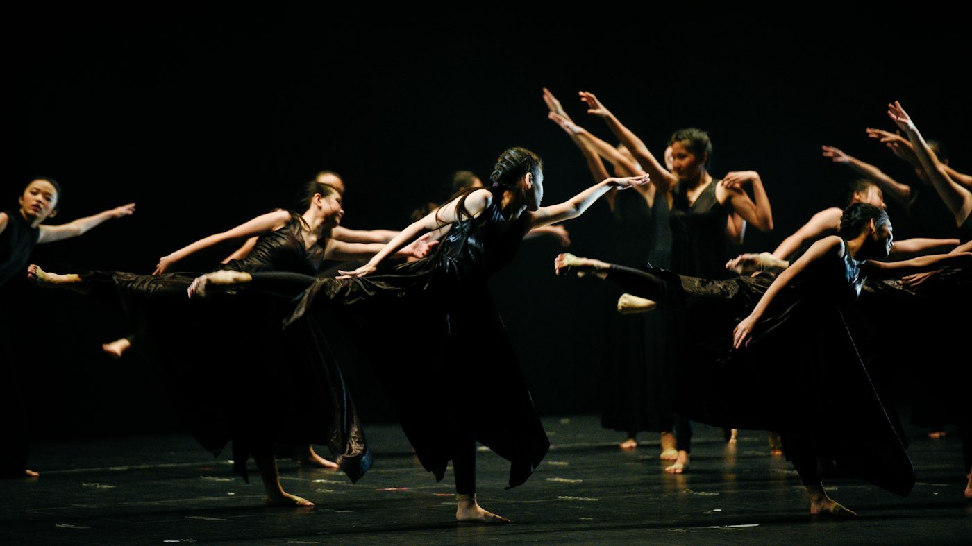 Groupe de danseurs sur un plateau noir